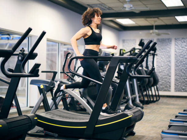 istock Athletic Woman Running on a Treadmill in a Gym 2059207474