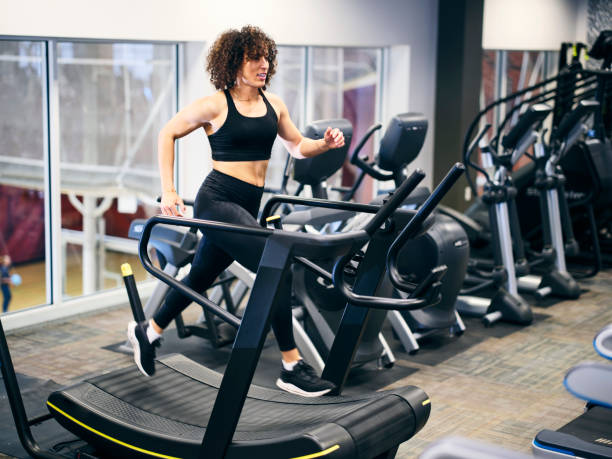 istock Athletic Woman Running on a Treadmill in a Gym 2059208523