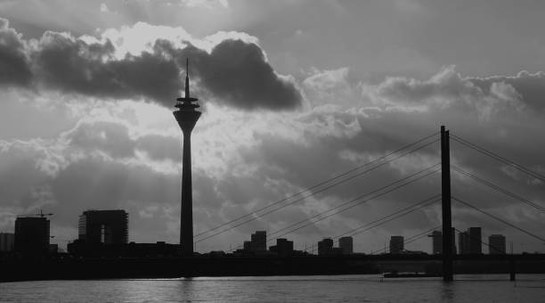This photo was shot on early December 2023, in Dusseldorf, Germany, and depicts the silhouettes of the city skyline at sunset, in a rather surrealistic way
