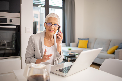 Senior entrepreneur is working from home