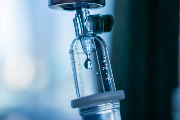 Close up medical intravenous IV drip in hospital background Close up medical intravenous IV drip in hospital background saline drip stock pictures, royalty-free photos & images