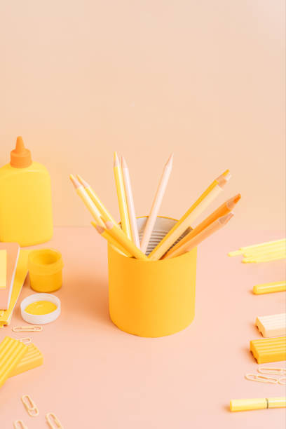 istock Yellow school stationery on a peach color background 2059321361