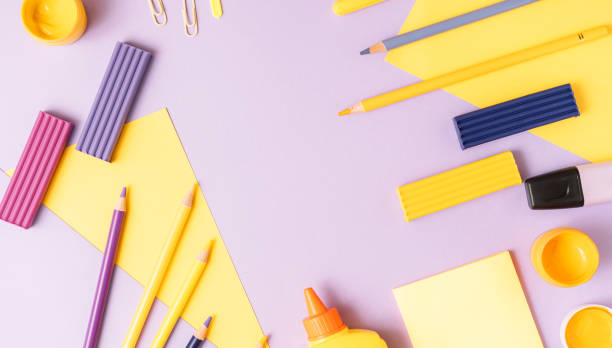 istock School stationery scattered on purple background 2059321371