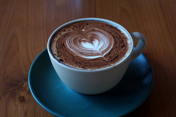 cup of hot latte art coffee stock photo