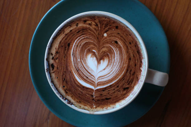 cup of hot latte art coffee stock photo