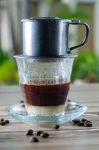 Vietnamese Style Drip Coffee with Condense Milk, Decorated with Coffee Bean. Selective Focus