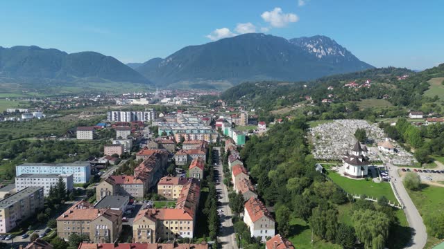 Aerial View of City in Romania with Transfagarasan Mountain Background