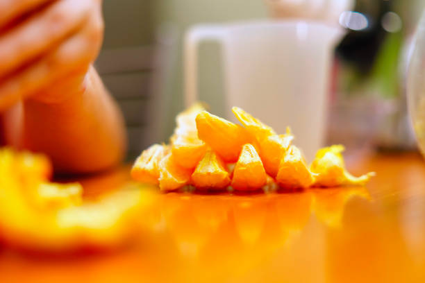 Orange slices lie on the table in a heap