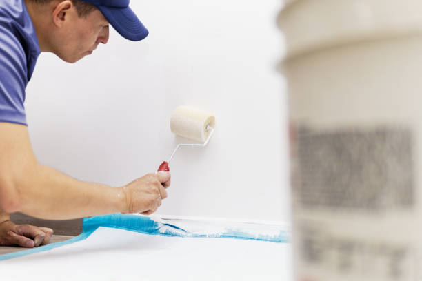 istock a young man painting a white house 2059464299