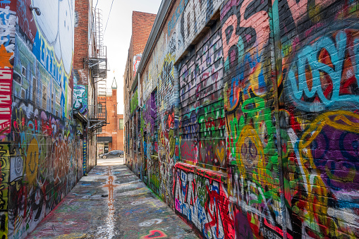 Toronto, Canada - May 02, 2020: Local man wearing face mask walking on the streets of Downtown Toronto during coronavirus pandemic in Ontario, Canada.