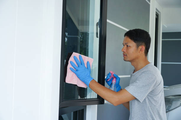istock a men cleaning a mirror of windows modern house. 2059597012