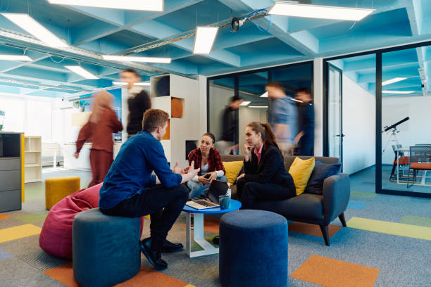 istock Multiethnic startup business team on meeting in a modern bright open space coworking office. Brainstorming, working on laptop. Group of coworkers walking around in motion blur 2059613005