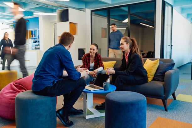 istock Multiethnic startup business team on meeting in a modern bright open space coworking office. Brainstorming, working on laptop. Group of coworkers walking around in motion blur 2059655276