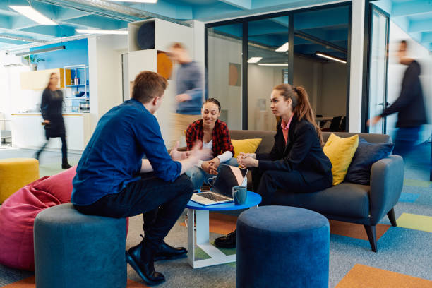 istock Multiethnic startup business team on meeting in a modern bright open space coworking office. Brainstorming, working on laptop. Group of coworkers walking around in motion blur 2059664688