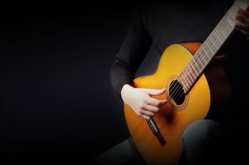Acoustic guitar player. Classical guitarist playing guitar classic music instrument closeup hands