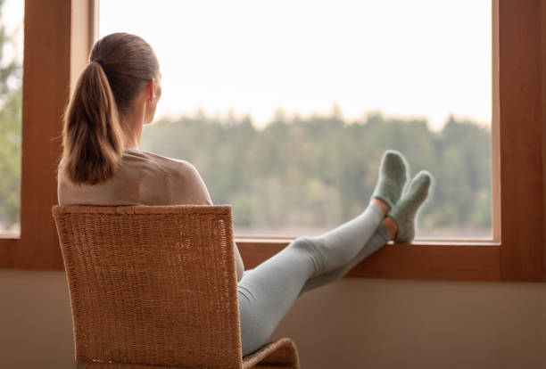 istock Woman looking out the window and enjoying beautiful view. 2059682743