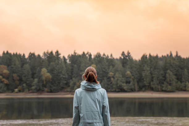 istock Woman watching a sunset by the lake. 2059683274