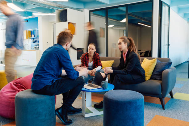 istock Multiethnic startup business team on meeting in a modern bright open space coworking office. Brainstorming, working on laptop. Group of coworkers walking around in motion blur 2059684310