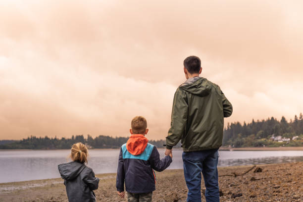 istock Father, son and daughter going for walk at sunset on the beach. 2059693260