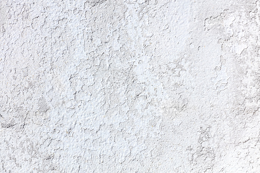 white painted concrete wall texture background. surface closeup.