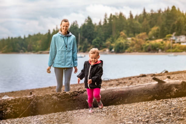 istock Mother and daughter having fun at the beach. 2059713615