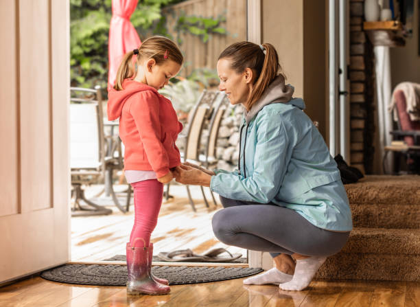 istock Mother helping daughter get ready for preschool. 2059723530
