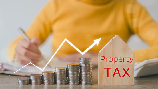 Property Tax Concept-House shape and stacked coins