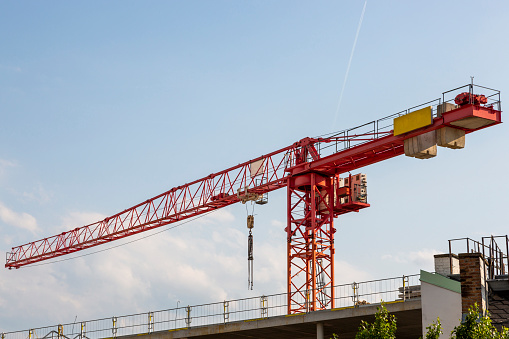 Frankfurt, Germany - September 27, 2023. A company crane atop a new build.