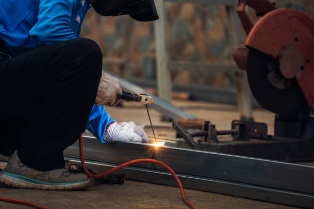 istock Construction Worker hands using Welding machinery iron metal sparking. Men hands wear protective glove Hot flame metal work cutting fire iron workshop. Locksmith use Welding machine cut metal process 2059791055