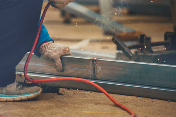 Female welding in her workshop. Woman at work