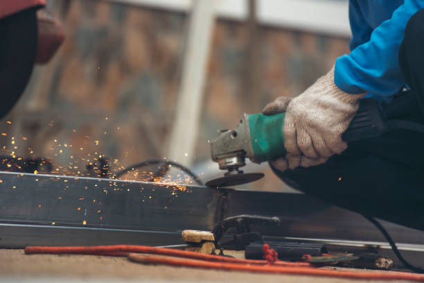 istock Construction Worker hands using Welding machinery iron metal sparking. Men hands wear protective glove Hot flame metal work cutting fire iron workshop. Locksmith use Welding machine cut metal process 2059791062