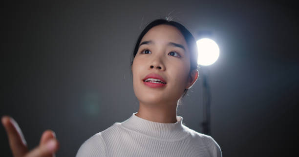 istock Close up girl's face is presenting a business plan on stage. 2059806790