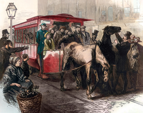 Vintage image features two horses straining to pull an overcrowded streetcar, symbolizing the struggle of cities with population growth surpassing infrastructure development. Scenes like this were all too common in the late 19th century where overcrowded cities reached unsustainable levels.