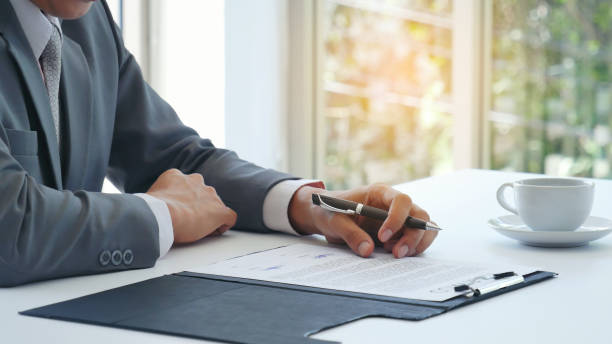 istock Businessman hand using pen signing on new contract starting projects in conference room. Close up business manager man hands sign contract legal document in meeting room. Business agreement concept 2059829782
