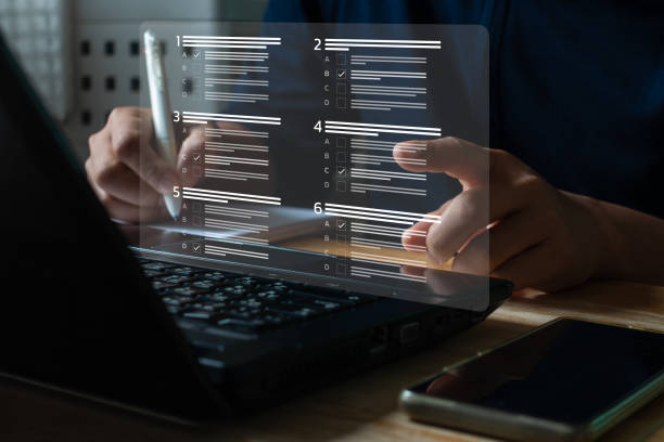 istock Education concept. Student use laptop computer to do online exam through the university website, choose correct answer in test knowledge, competence assessment, and E-learning. Fill out survey form. 2059856927