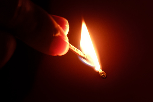 Fire of a match. Macro shooting, close-up. The fading of the match. Charred wood, smoke. High quality photo