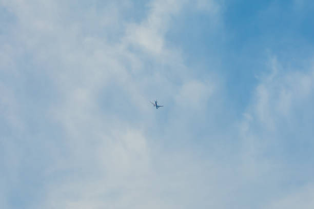 istock airplane flying in the blue sky 2059906541