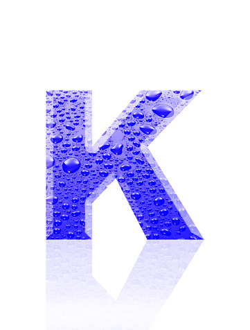 Close-up of three-dimensional water droplets alphabet letter K on white background.