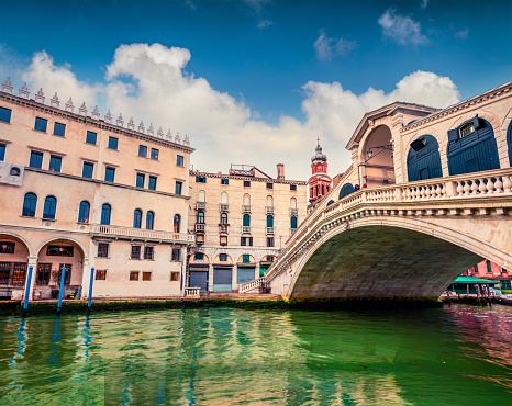 Beautiful spring view of famous Canal Grande. Colorful spring scene of Rialto Bridge. Picturesque evening cityscape of  Venice, Italy, Europe. Traveling concept background.