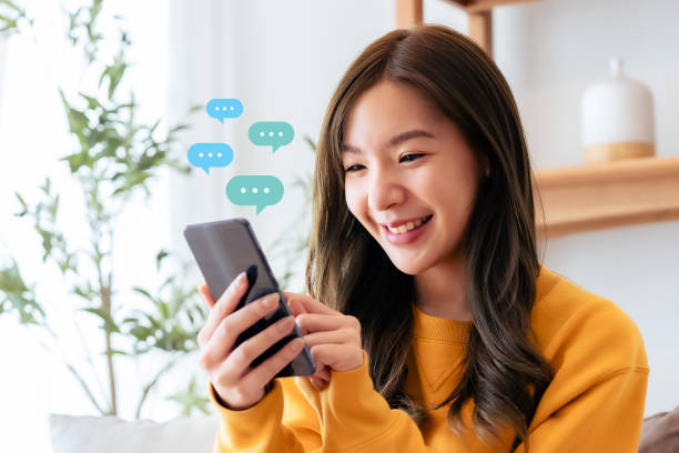 istock Adorable young Asian woman using mobile smartphone. Online live chat chatting on application communication digital media website and social network 2059924675