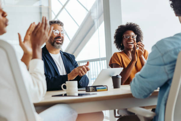 istock Diverse business team celebrating successful project in a boardroom 2059940466