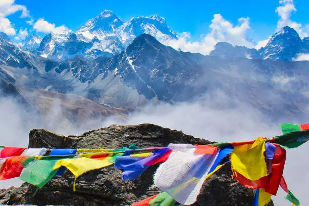 Picturesque view of great Himalayan panorama with Everest and Lhotse dominating the horizon with prayer flags in foreground seen from top of Gokyo Ri in Nepal