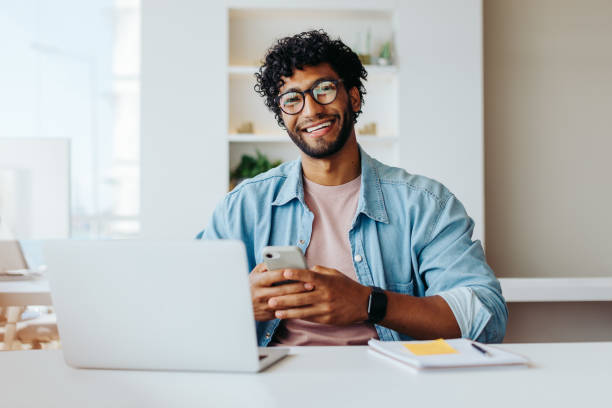 istock Smiling young entrepreneur at modern office workspace 2059941529