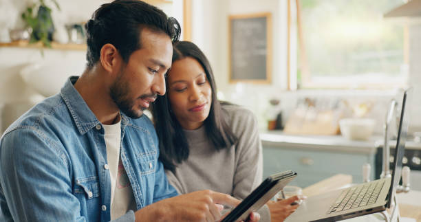 istock Kitchen, talking and couple with a tablet, planning a meal and communication with social media, home and internet connection. Network, man or woman with technology, speaking and website information 2059950936