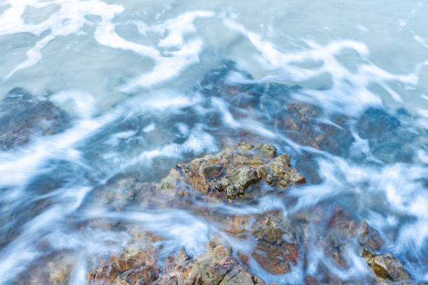 waves crash on the rocky beach.