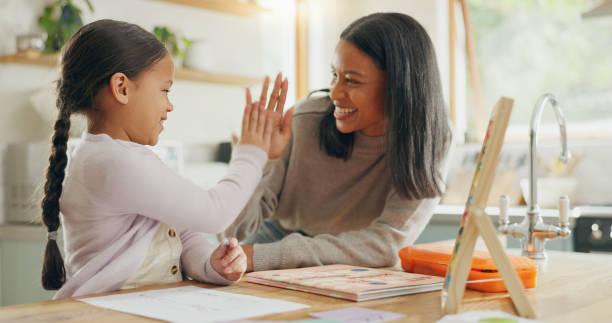 istock Learning, high five and mother with girl for home education, language success, support and love, hug and teaching. Helping, yes and happy family, mom and child for school writing and drawing on paper 2059976229