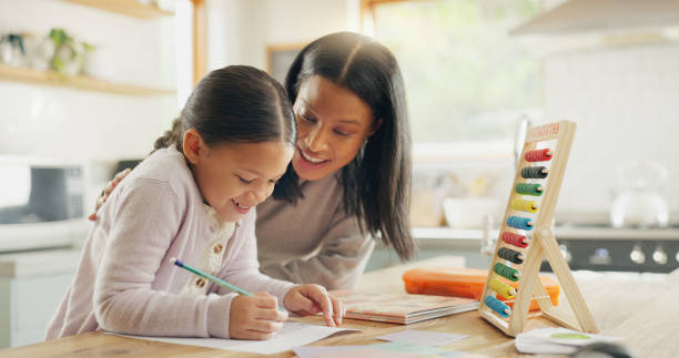 istock Homework, mother and girl with education, teaching and conversation with support, help and knowledge. Female child writing, student or mama with a kid, kitchen and learning with growth or development 2059976231