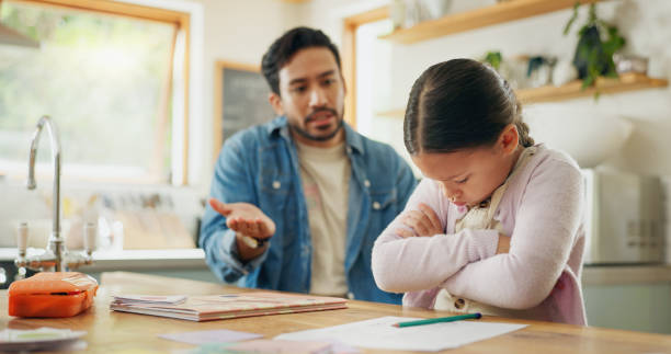 istock Angry dad with crying child, homework and scolding in kitchen, helping to study with conflict. Learning, teaching and frustrated father with sad daughter for discipline, education and problem in home 2059978129