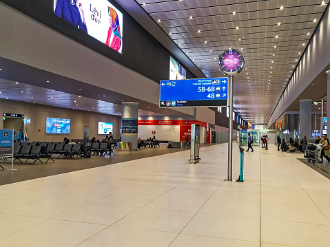 Istanbul, Turkey - October 28, 2019: Istanbul Airport arrivals area interior with clock and information sign. Modern terminal interior design