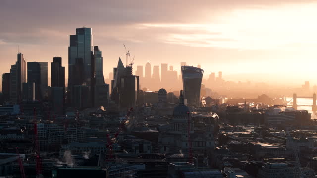 Aerial slider shot of central London with Canary wharf in the background at sunrise